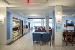 a dining room with blue chairs and a table at Holiday Inn Express & Suites Tupelo, an IHG Hotel in Tupelo