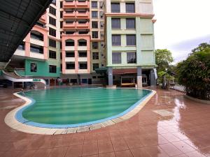 an empty swimming pool in front of some buildings at EagleNest at Marina Cove Resort in Lumut