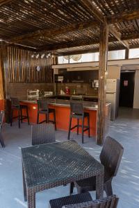 a kitchen area with a table and chairs at Desert Nights Hostel in Ica