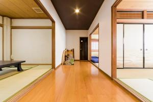a living room with a table and a mirror at Tessen Guesthouse in Shizuoka