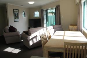 ein Wohnzimmer mit einem Sofa und einem Tisch in der Unterkunft Haven On Carroll in Palmerston North