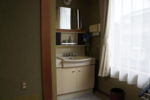 a bathroom with a sink and a window at Sumiyoshiya in Kanazawa