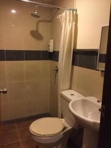 a bathroom with a toilet and a sink at Hotel Sri Sutra PJ 222 in Petaling Jaya