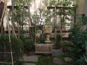 a garden in front of a building with trees at Sumiyoshiya in Kanazawa