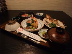 a tray with plates of food on a table at Sumiyoshiya in Kanazawa