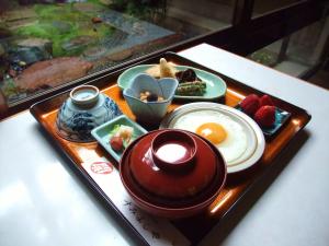a tray of food with eggs and strawberries on a table at Sumiyoshiya in Kanazawa