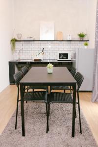a black table and chairs in a kitchen at Langkawi Green View Cottage in Pantai Cenang