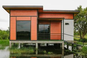 a small house in the water at Langkawi Green View Cottage in Pantai Cenang