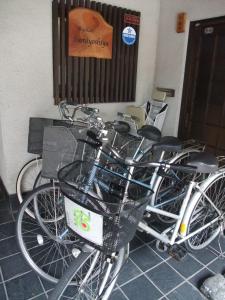 a couple of bikes parked next to a wall at Sumiyoshiya in Kanazawa