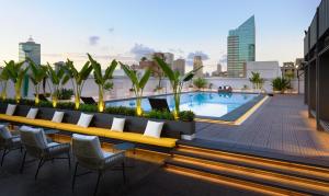 a rooftop patio with a pool on a building at The Howard Plaza Hotel Kaohsiung in Kaohsiung
