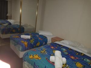 a bedroom with two beds with stuffed animals on them at Accommodation Sydney City Centre - 2 Bedroom Apartment with Balcony on Top Floor in Sydney