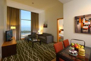 a hotel room with a living room with a view at Holiday Inn Melaka by IHG in Malacca +107 photos