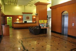 um lobby com uma sala de espera com um sofá em Strand Hotel em Singapura