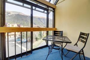 a table and chairs in a room with a large window at WH301 Wheeler House condo in Copper Mountain