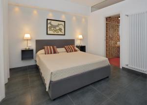 a bedroom with a large bed with two pillows at B&B Dimora Tomasi in Palermo