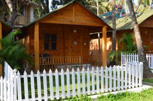 a white picket fence in front of a house at Kings Villa Resort in Palolem