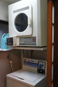 a microwave oven sitting on top of a refrigerator at Sumiyoshiya in Kanazawa