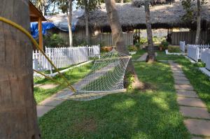 a hammock in a yard next to a fence at Kings Villa Resort in Palolem
