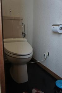 a toilet in a bathroom with a roll of toilet paper at Sumiyoshiya in Kanazawa