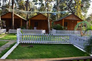 a white picket fence in front of a house at Kings Villa Resort in Palolem