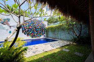 a pool in a backyard with a bunch of balloons at ViaVia Guesthouse in Yogyakarta