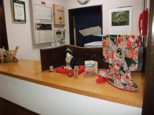 a counter top with a doll and boots on it at Sumiyoshiya in Kanazawa