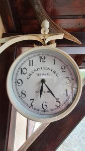 a clock hanging from the ceiling of a building at Casa Teleferic in Buşteni