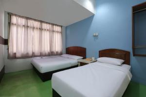 Postel nebo postele na pokoji v ubytování Impiana Hotel
