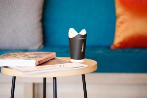 a small table with a book and a cup on it at Hot Cross Point Santa Monica in Miyako Island