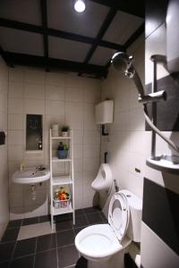 a bathroom with a toilet and a sink at Private Getaway (Private Cinema, Swing & more!) at CEO Penang in Bayan Lepas