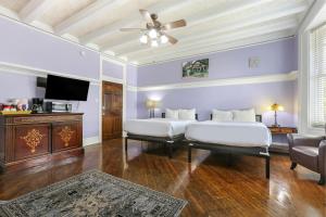 a bedroom with two beds and a flat screen tv at Newly-renovated Express Studios Close to City Amenities in New Orleans