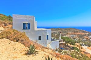 a white house on a hill with the ocean at Sifnos Residence in Platis Gialos +18 photos