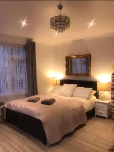 
a bedroom with a bed and a lamp on the wall at Brick lane stay in London
