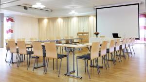 a conference room with a long table and chairs at Thon Hotel Surnadal in Surnadal