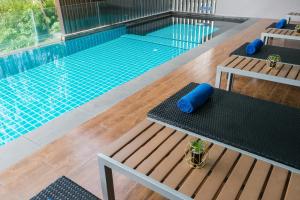 The swimming pool at or near Aster Hotel and Residence by At Mind
