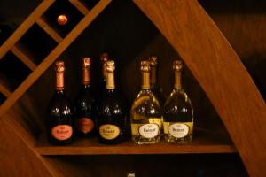 a group of wine bottles sitting on a shelf at Agriturismo Grammelot in Sarnico