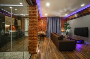 a living room with a couch and a tv at Apartament on Gorkogo 23 in Bobruisk