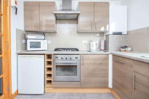 a kitchen with a stove and a microwave at Innes Street Apartments in Inverness