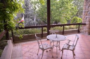 a patio with a table and chairs and a flag at Massabki Hotel in Chtaura