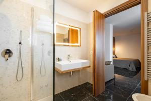 a bathroom with a sink and a shower at Hotel Mare in Lignano Sabbiadoro +131 photos