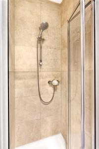 a bathroom with a shower with a glass door at Granville Apartments Harrogate in Harrogate