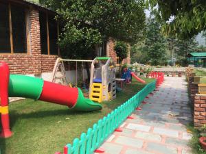 a playground in a yard with a slide at Pacific Inn Resort Rishikesh in Rishīkesh