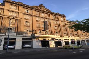 a large building with cars parked in front of it at Hotel Barão De Tefé in Rio de Janeiro