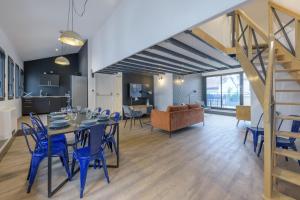 a dining room and living room with a table and chairs at NOCNOC - Le Raphael in Lyon