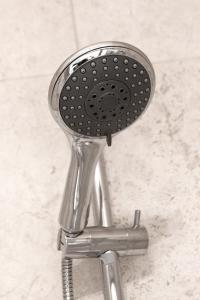 a shower head sitting on top of a chrome stool at Granville Apartments in Harrogate