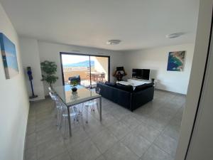 a living room with a table and a couch at Porticcio Vacances in Porticcio