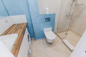 a bathroom with a toilet sink and a shower at CityApartments Kyiv Palace "Ukraine" in Kyiv