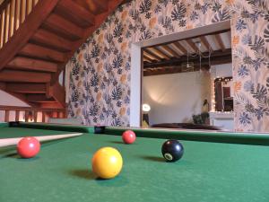 a pool table with balls on it in a room at La Closerie Teranga in Bayeux