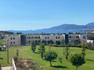 a view of a building with a field and trees at Porticcio Vacances in Porticcio