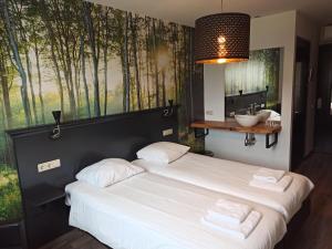 Ένα ή περισσότερα κρεβάτια σε δωμάτιο στο Hotel De Kruishoeve 's-Hertogenbosch - Vught